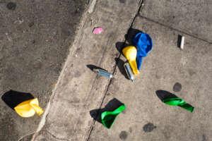 BUnte Luftballons und Gaskartuschen auf Asphalt